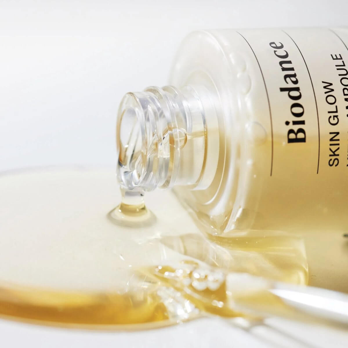 Biodance Skin Glow Vital Ampoule spilling, showcasing its hydrating formula enriched with probiotics and hyaluronic acid.