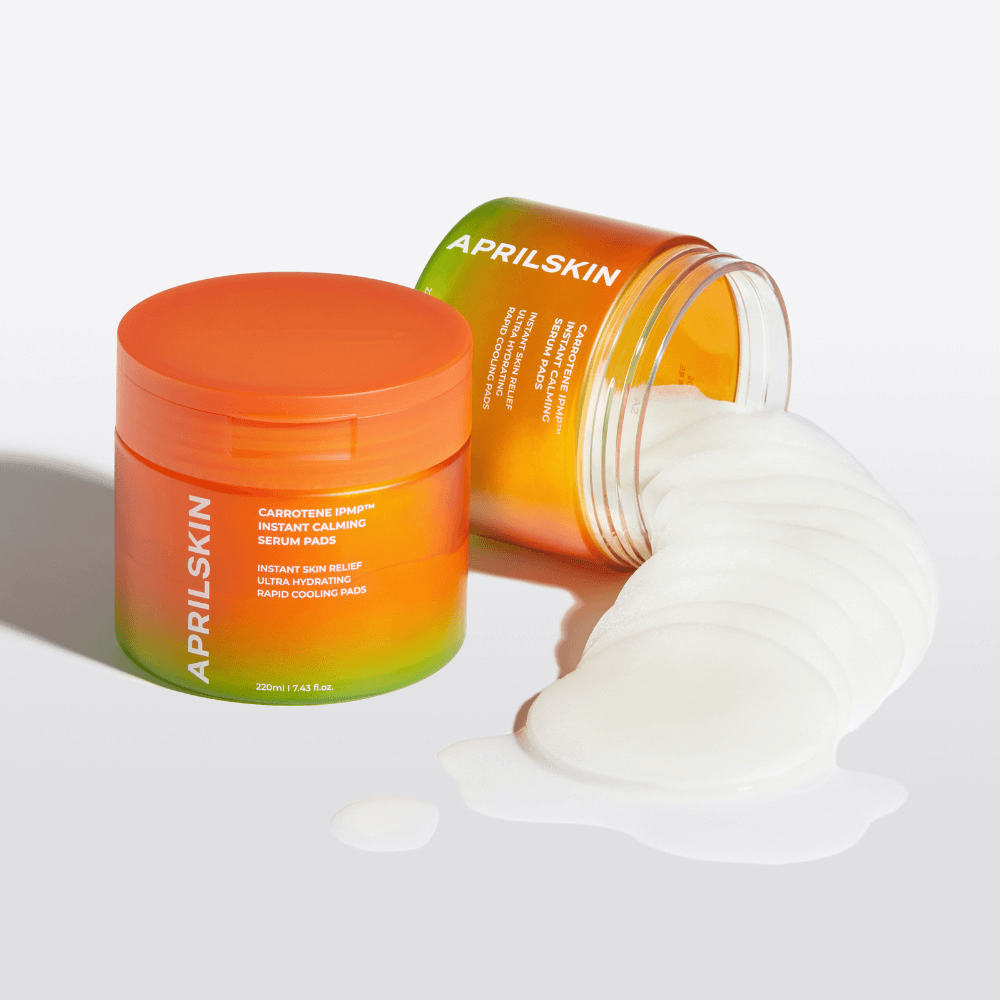 APRIILSKIN Carrotene IPMP Instant Calming Serum Pads in vibrant packaging with pads spilled out, promoting skin soothing and pore reduction.