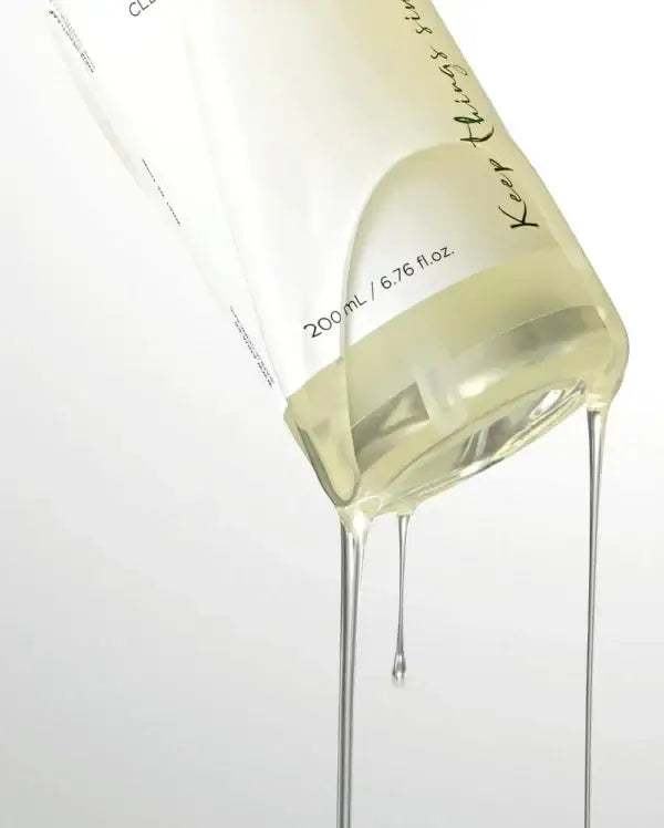 ANUA Heartleaf Pore Control Cleansing Oil bottle pouring with golden oil, suitable for all skin types, 200ml.