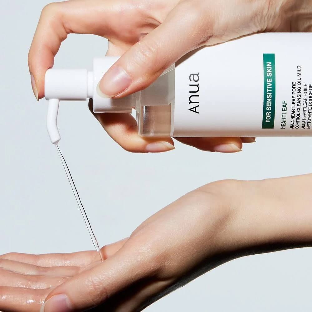 ANUA Heartleaf Pore Control Cleansing Oil being poured onto a hand, suitable for sensitive skin and non-comedogenic.