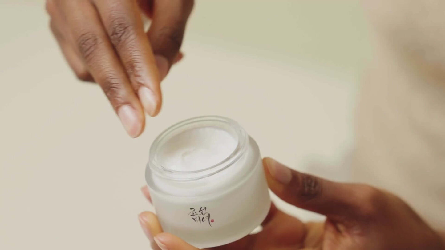 Beauty of Joseon Dynasty Cream 50ml in a jar, showing a person applying moisturizer for healthy, glowing skin.