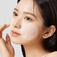 Woman applying APRILSKIN Carrotene IPMP Instant Calming Serum Pad for soothing skincare.