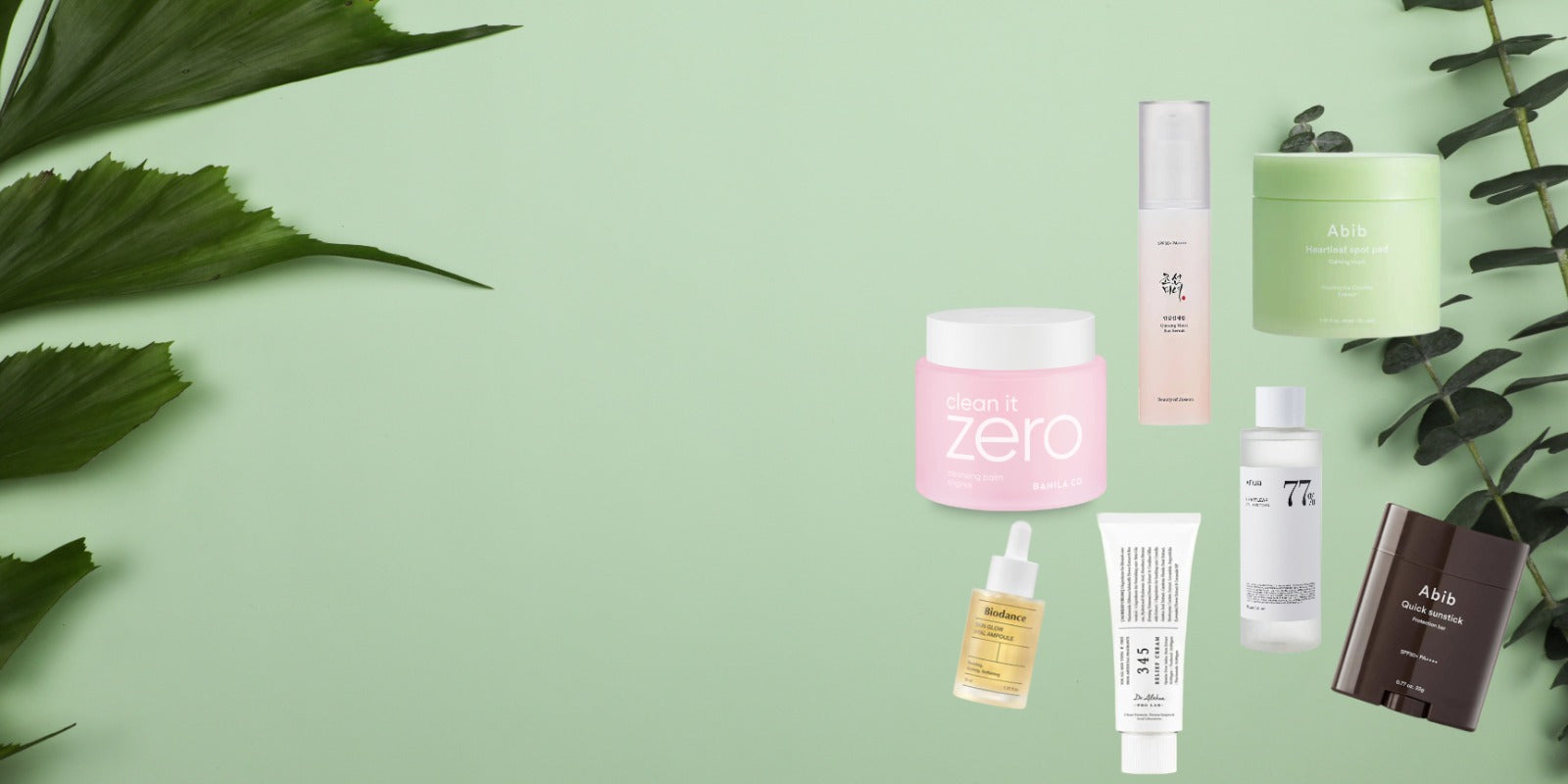 Collection of skincare products on a green background with leaves, featuring creams, serums, and a toner.