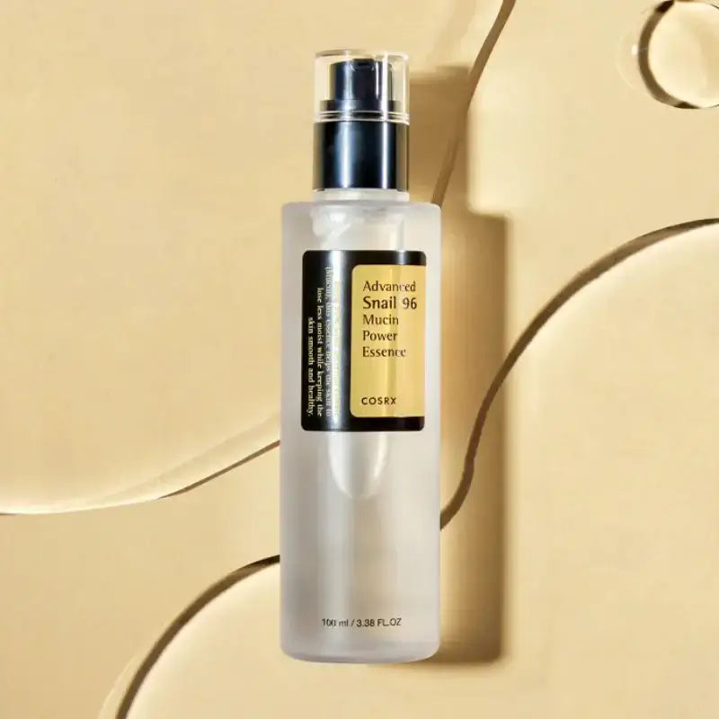 COSRX Advanced Snail 96 Mucin Power Essence 100ml bottle on a beige background, hydrating essence for all skin types.