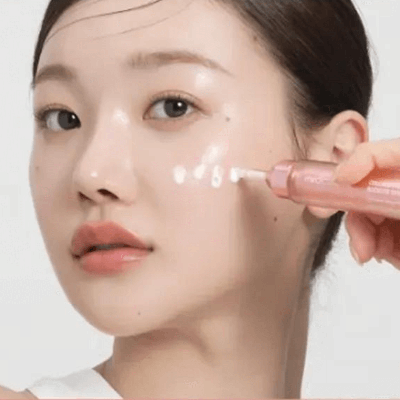 Applying Medicube Collagen Glow Booster Serum for healthy, glowing skin and enhanced elasticity.