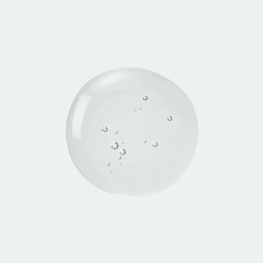 Close-up of Jumiso Snail Mucin 95 + Peptide Facial Essence texture, showcasing a clear gel with air bubbles.