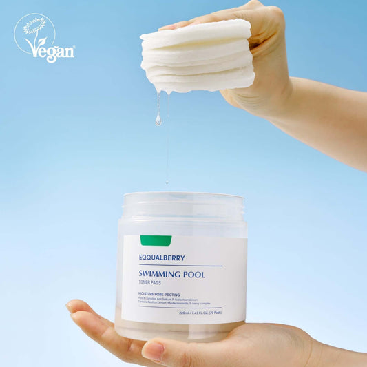 EQQUALBERRY Swimming Pool Toner Pads in a hand, showcasing a vegan skincare product for gentle exfoliation.