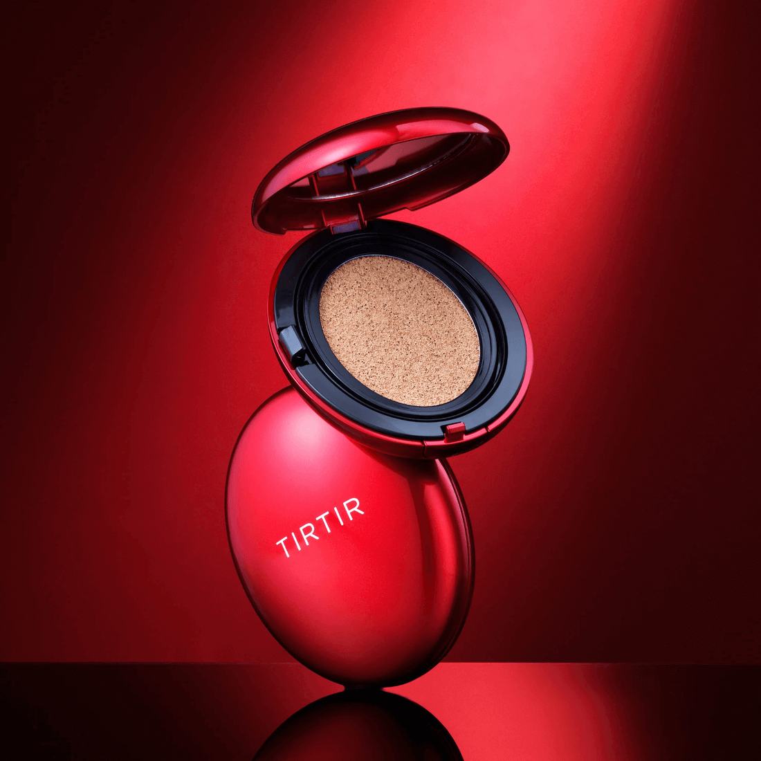 TIRTIR Mask Fit Red Cushion with open lid showcasing the cushion inside, set against a red backdrop.